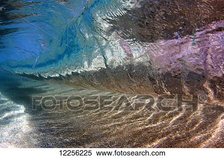 Stock Photography - Underwater view of a breaking wave; Hawaii, United States of America. Fotosearch