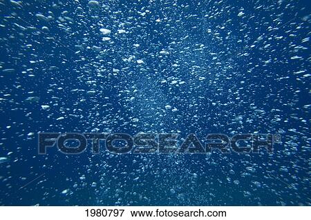 Stock Photo - Underwater View Of Air Bubbles Rising Through Blue Ocean Water.. Fotosearch