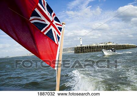 Stock Image - Union Jack Flag On Boat And The Boat's Wake. Fotosearch