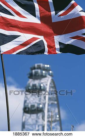 Stock Photo - Union Jack With Millennium Wheel Behind, Close Up. Fotosearch