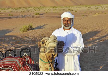 United Arab Emirates, Abu Dahbi, Camel and guide in Liwa desert View Large Photo Image Stock Image - United Arab Emirates, Abu Dahbi, Camel and guide in Liwa desert. Fotosearch