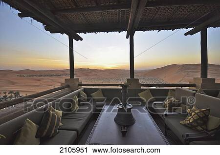 Stock Image - United Arab Emirates, Abu Dahbi, Empty Quarter, Liwa desert dune, Qasr al Sarab, Sunset on terrace. Fotosearch
