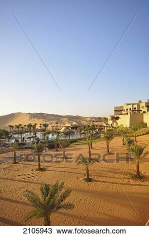 Stock Image - United Arab Emirates, Abu Dahbi, Qasr al Sarab, Main pool and dunes. Fotosearch
