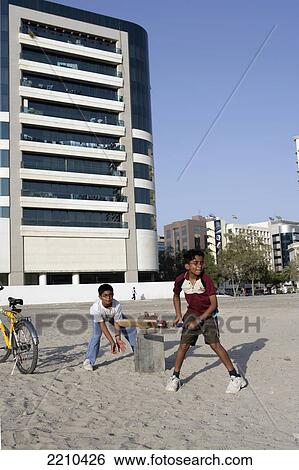 United Arab Emirates, Children Playing Cricket On Waste Ground; Dubai View Large Photo Image Stock Photograph - United Arab Emirates, Children Playing Cricket On Waste Ground; Dubai. Fotosearch