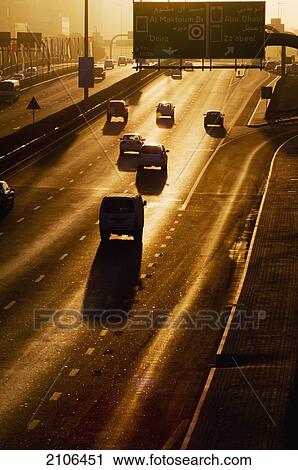 Stock Image - United Arab Emirates, City traffic in morning light; Dubai. Fotosearch