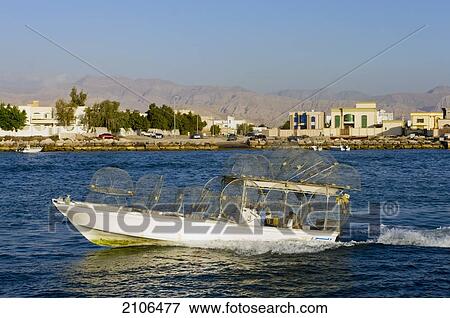 Stock Photo - United Arab Emirates, Fishing boat leaving harbour; Ras Al Khaimah. Fotosearch