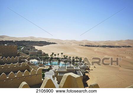 Stock Image - United Arab Emirates, Qasr al Sarab; Abu Dhabi, Main pool and Royal Villas in distance. Fotosearch