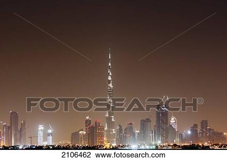 Stock Image - United Arab Emirates, View of city skyline at night; Dubai. Fotosearch