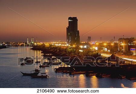 Stock Image - United Arab Emirates, View of city skyline at dusk; Ras Al Khaimah. Fotosearch