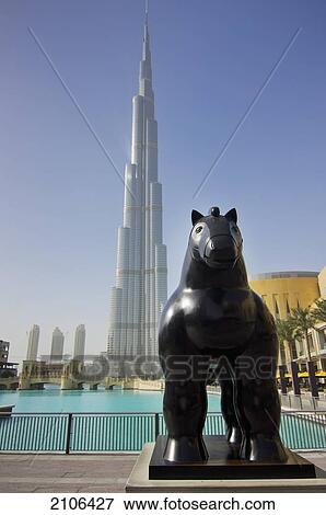 Stock Photo - United Arab Emirates, View of horse statue with Burj Khalifa hotel in background; Dubai. Fotosearch