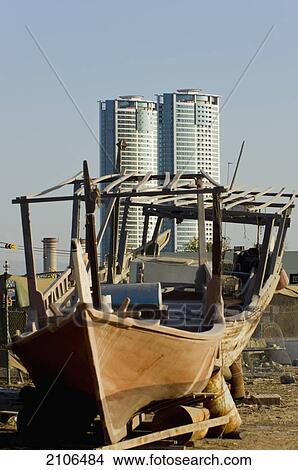 Picture - United Arab Emirates, View of old dhow and skyscraper in background; Ras Al Khaimah. Fotosearch