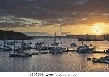 Stock Image - United Kingdom, England, Cornwall, Sunrise in harbor; Falmouth. Fotosearch