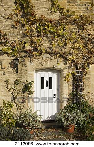 Stock Photograph - United Kingdom, England, Cotswolds, Lower Slaughter, doorway of row house.. Fotosearch