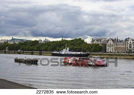 Stock Photography - United Kingdom, England, River Cruise boat and HMS President ship on Thames river; London. Fotosearch