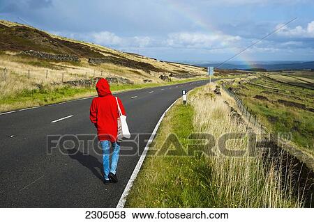 United Kingdom, England, Woman in red coat walking along A635 Greenfiled road. Rainbow in distance; Yorkshire View Large Photo Image Stock Photo - United Kingdom, England, Woman in red coat walking along A635 Greenfiled road. Rainbow in distance; Yorkshire. Fotosearch