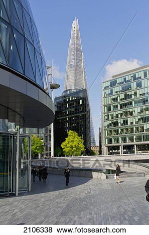 Stock Photo - United Kingdom, More London; London, View of Shard building with City Hall in foreground. Fotosearch