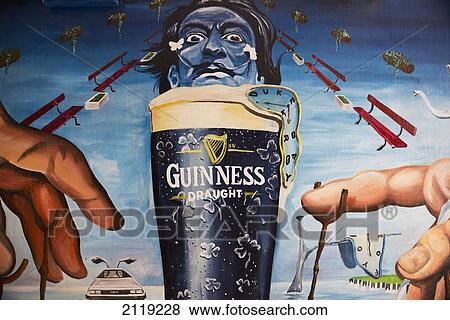 Stock Photo - United Kingdom, Northern Ireland, Dali style mural of pint of Guinness; Belfast. Fotosearch