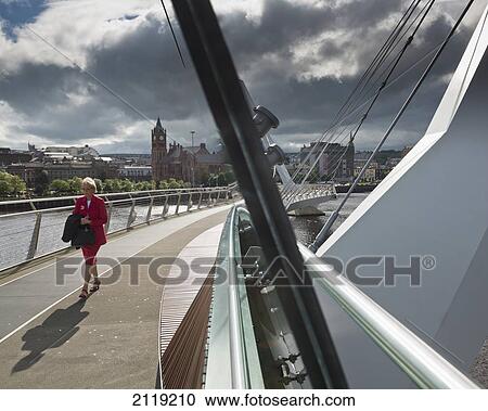 United Kingdom, Northern Ireland, County Londonderry, Woman walking Peace Bridge; Derry View Large Photo Image Stock Image - United Kingdom, Northern Ireland, County Londonderry, Woman walking Peace Bridge; Derry. Fotosearch