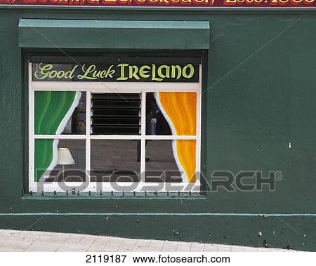 Stock Photo - United Kingdom, Northern Ireland, County Londonderry, Window of local bar; Derry. Fotosearch