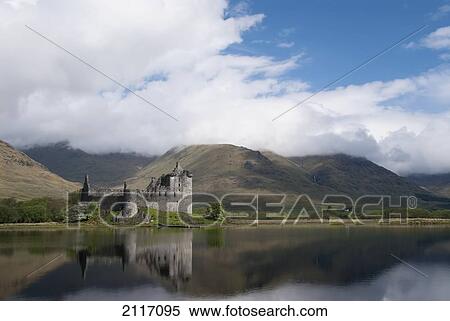 Stock Photography - United Kingdom, Scotland, Kilcurn Castle on a peninsula at the end of Loch Awe, Castle reflecting in water.. Fotosearch