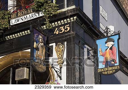 Stock Photo - United Kingdom, Scotland, Low angle view of commercial signs of traditional pub on Lawnmarket; Edinburgh. Fotosearch