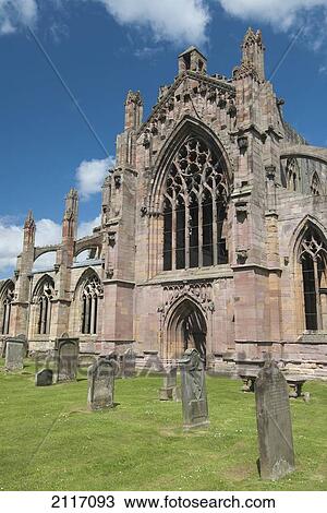 Stock Image - United Kingdom, Scotland, Melrose, Entrance to the ruins of the Melrose Abbey, Founded by monks in 1136.. Fotosearch
