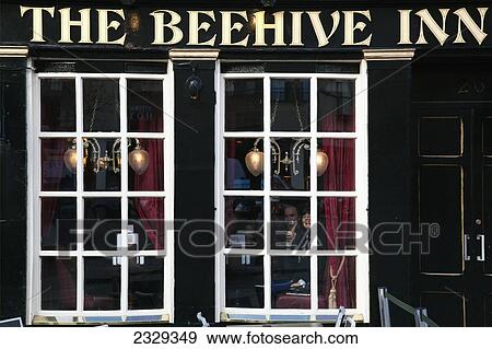 Stock Photo - United Kingdom, Scotland, Tourists inside traditional pub; Edinburgh. Fotosearch
