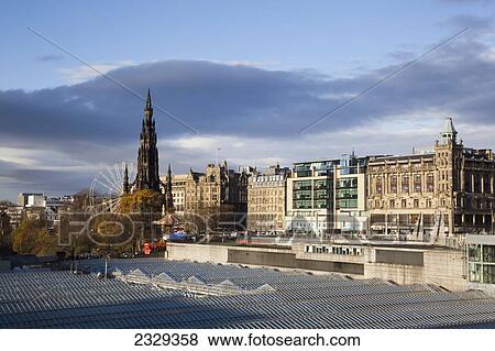 Stock Photo - United Kingdom, Scotland, View of roofs and Princess Street Gardens with Scott Monument in background; Edinburgh. Fotosearch