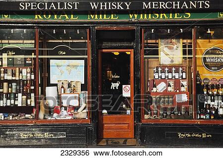 Stock Photograph - United Kingdom, Scotland, Window display of Whisky shop on Royal Mile; Edinburgh. Fotosearch