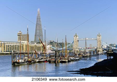 Stock Photo - United Kingdom, View of sailing boats on Thames with Tower Bridge and Shard building in background; London. Fotosearch