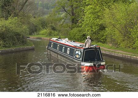 Stock Photograph - United Kingdom, Wales, Llangollen Canal, Narrow Boat Cruising the Canal. Fotosearch