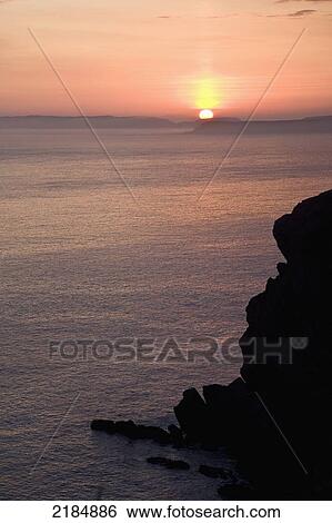 Stock Photograph - United Kingdom, Wales, Pembrokeshire, Cliffs At Sunset; Dale. Fotosearch