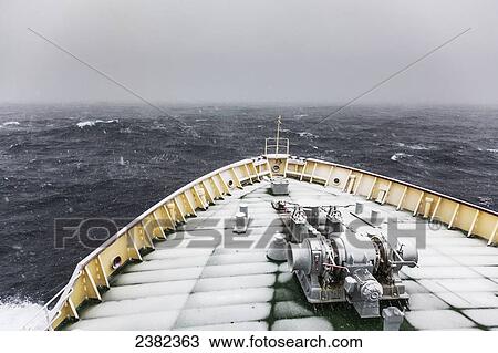Stock Image - United States Coast Guard Polar Star icebreaker with a snow covered deck in the Southern Ocean; Antarctica. Fotosearch