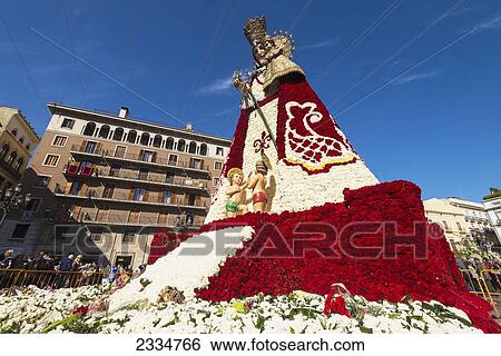 Stock Photograph - Upward View Of Virgin De Los Desamparados (Holy Virgin Of Lonely And Homeless. ) During Fallas Festival; Valencia, Spain. Fotosearch