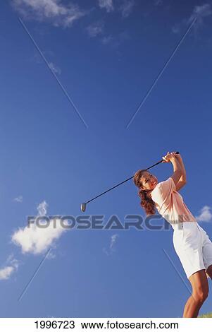 Upward View Of Woman Swinging Golf Club, Tilted Angle Against Blue Sky With Clouds View Large Photo Image Stock Image - Upward View Of Woman Swinging Golf Club, Tilted Angle Against Blue Sky With Clouds. Fotosearch