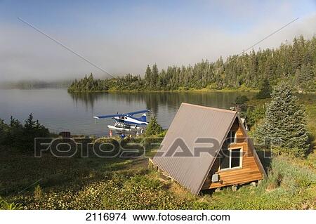 Picture - USA, Alaska, Prince William Sound, Shrode Lake, float plane parked by US Forest Service cabin.. Fotosearch