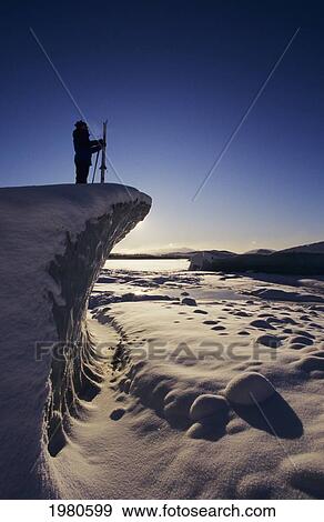Stock Photo - USA, Alaska, Skier overlooking snowy landscape at Mendenhall Glacier; Juneau. Fotosearch