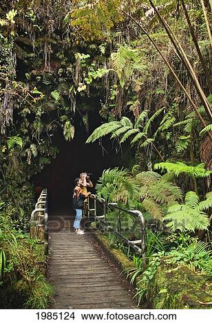 Picture - USA, Big Island. Hawaii Islands, Couple at entrance to Thurston Lava Tube; Hawaii Volcanoes National Park. Fotosearch