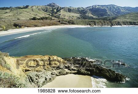 Stock Photo - USA, California, Ocean's landscape surrounded by dry hills on coastline; Big Sur. Fotosearch