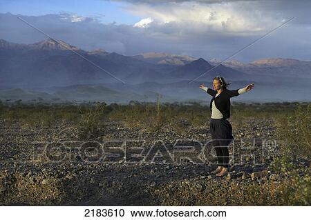 Usa, California, Woman Standing At Mesquite Flat Dunes And Amargosa Range Mountains; Death Valley National Park View Large Photo Image Stock Image - Usa, California, Woman Standing At Mesquite Flat Dunes And Amargosa Range Mountains; Death Valley National Park. Fotosearch