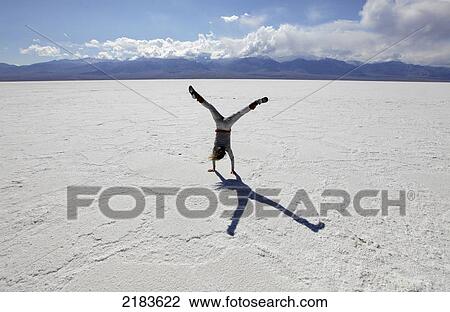 Usa, California, Young Woman Doing Cartwheel On Badwater Salt Flats; Death Valley National Park View Large Photo Image Stock Image - Usa, California, Young Woman Doing Cartwheel On Badwater Salt Flats; Death Valley National Park. Fotosearch