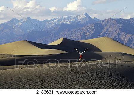 Usa, California, Young Woman Doing Cartwheel On Mesquite Flat Sand Dunes With Amargosa Range Mountains In Background; Death Valley National Park View Large Photo Image Stock Image - Usa, California, Young Woman Doing Cartwheel On Mesquite Flat Sand Dunes With Amargosa Range Mountains In Background; Death Valley National Park. Fotosearch