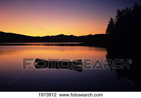 USA, Canoe Floating On Calm Lake At Sunset; Alaska View Large Photo Image Stock Image - USA, Canoe Floating On Calm Lake At Sunset; Alaska. Fotosearch