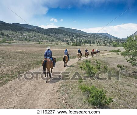 Stock Photo - USA, Colorado, Big Thompson River Valley; Loveland, Horseback riding at Sylvan Dale Ranch. Fotosearch