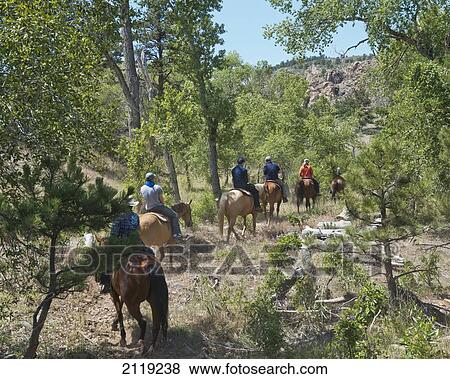 Stock Photo - USA, Colorado, Big Thompson River Valley; Loveland, Horseback riding at Sylvan Dale Ranch. Fotosearch