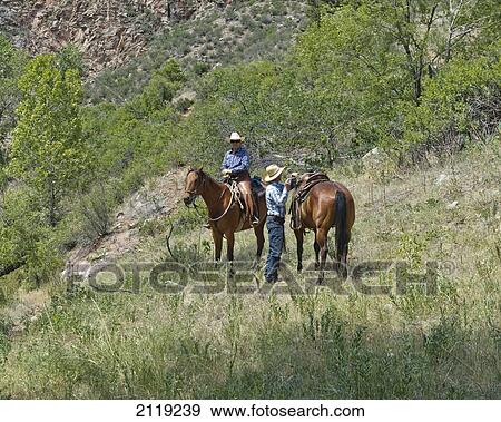 Stock Photo - USA, Colorado, Big Thompson River Valley; Loveland, Horseback riding at Sylvan Dale Ranch. Fotosearch