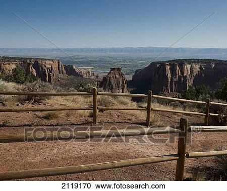 Stock Image - USA, Colorado, Magnificent views of sheer rock canyons and red sandstone monoliths; Colorado National Monument. Fotosearch