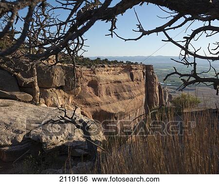 Stock Photograph - USA, Colorado, Magnificent views of sheer rock canyons and red sandstone monoliths; Colorado National Monument. Fotosearch