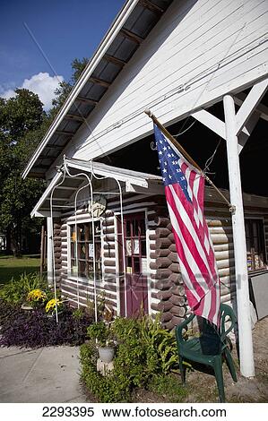 Stock Photography - Usa, Florida, American Flag At Shop Entrance; Micanopy. Fotosearch