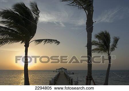 Stock Photography - USA, Florida, Florida Keys, Sunrise over pier and boat dock at luxurious Cheeca Lodge; Islamorada. Fotosearch